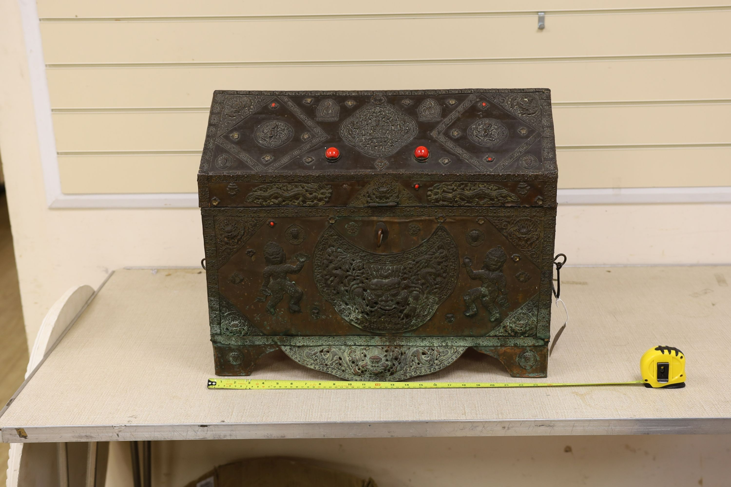 A Tibetan copper repousse-work casket, 20th century, 65cm wide, 49.5cm